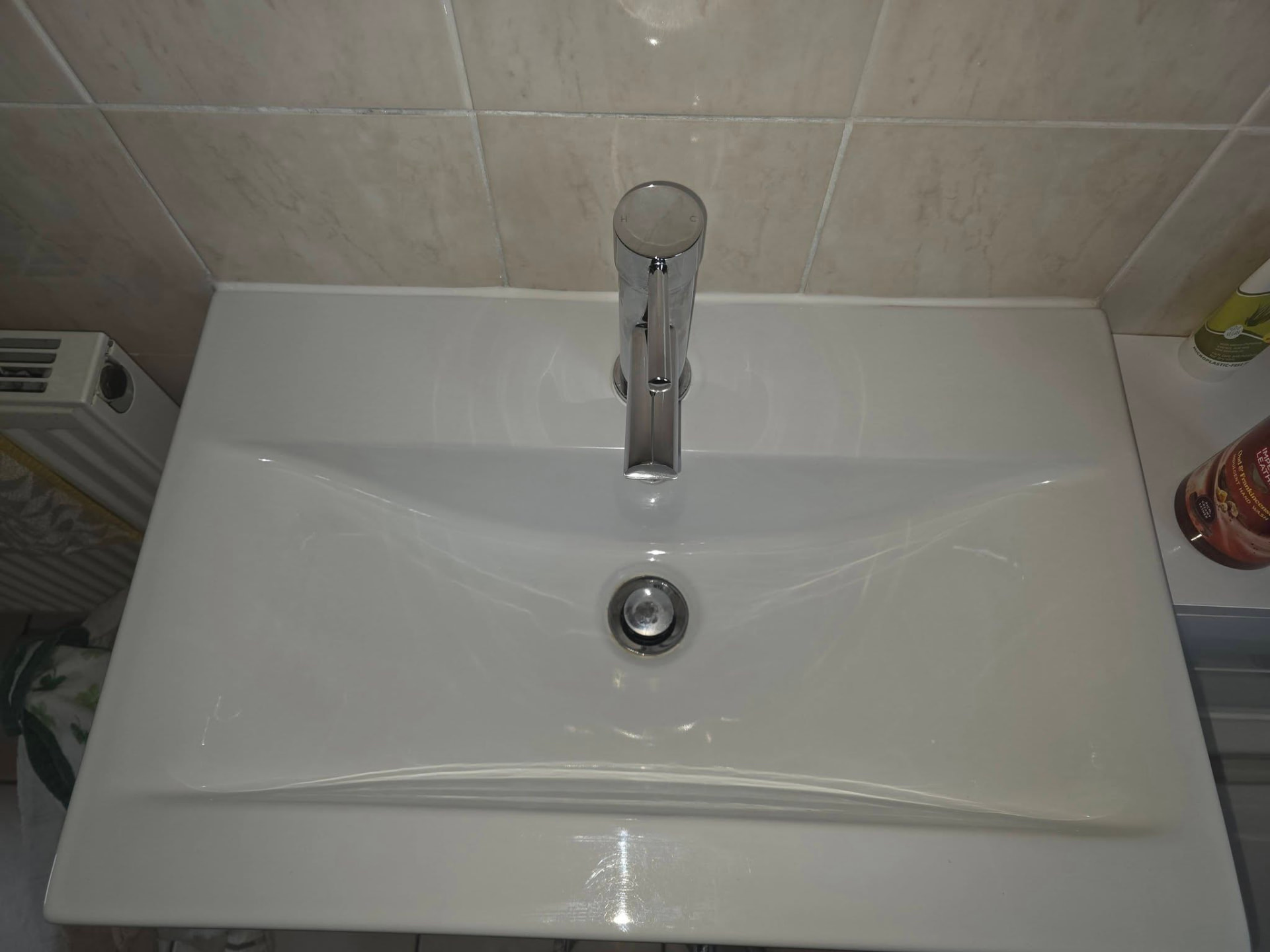 Bathroom basin and tap polished after cleaning