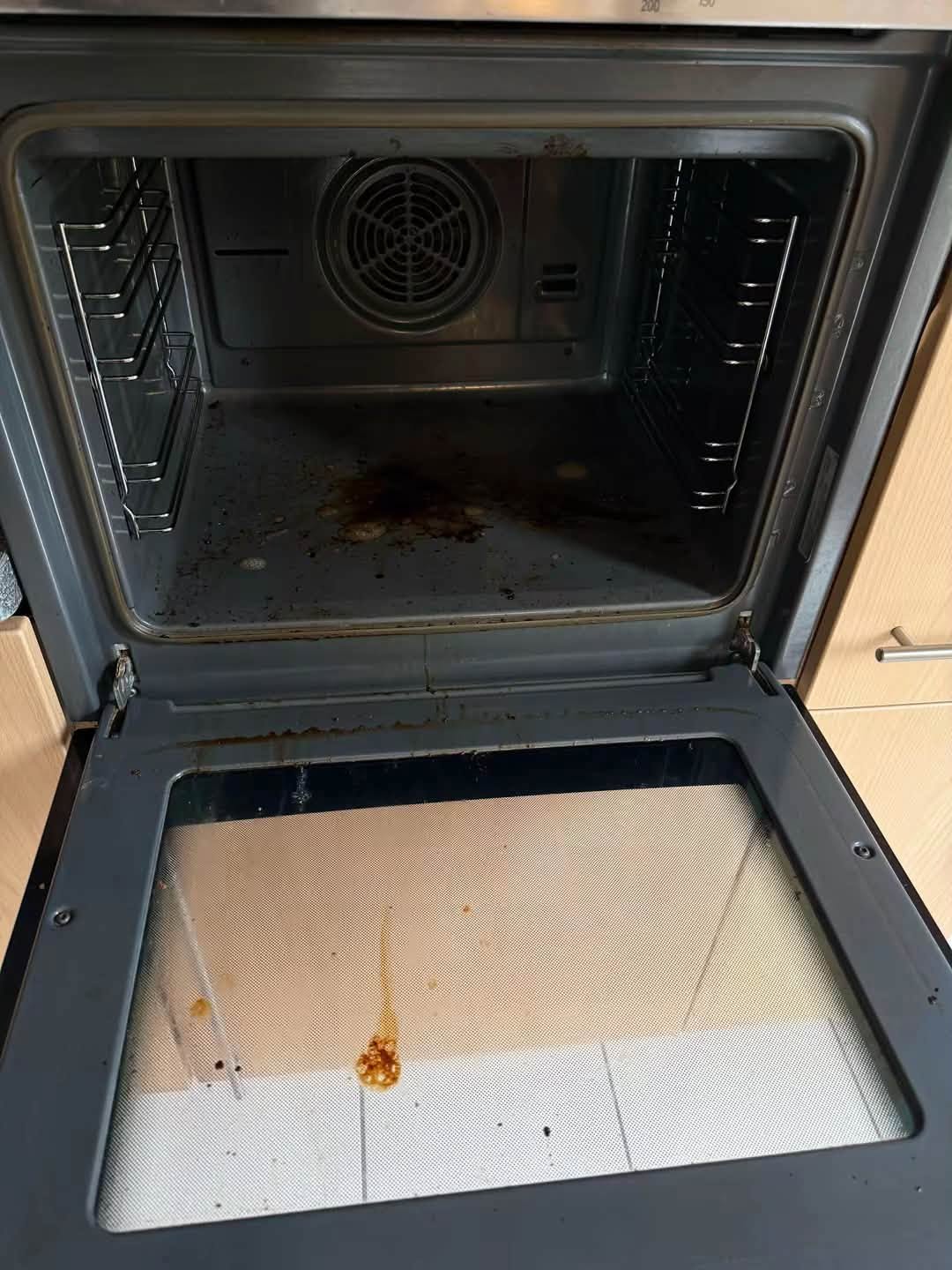 Oven interior with baked-on grease before cleaning